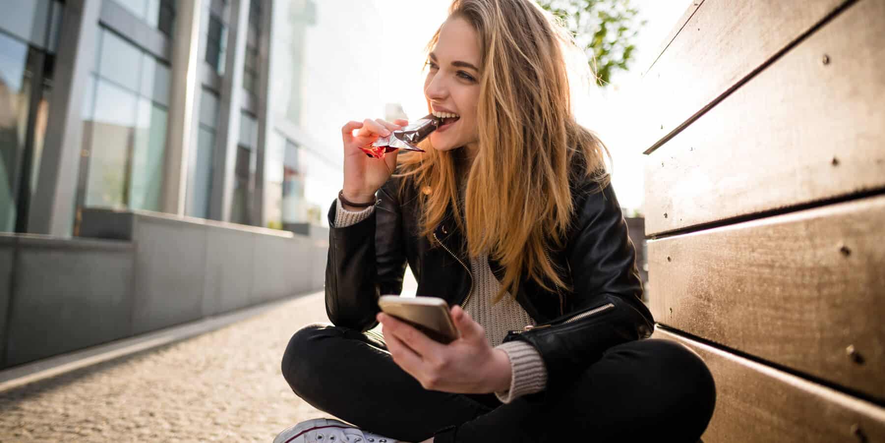 Woman eating a Malteasers teaser bar as part of sampling campaign
