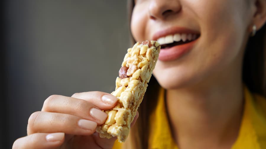 Woman eating a granola bar