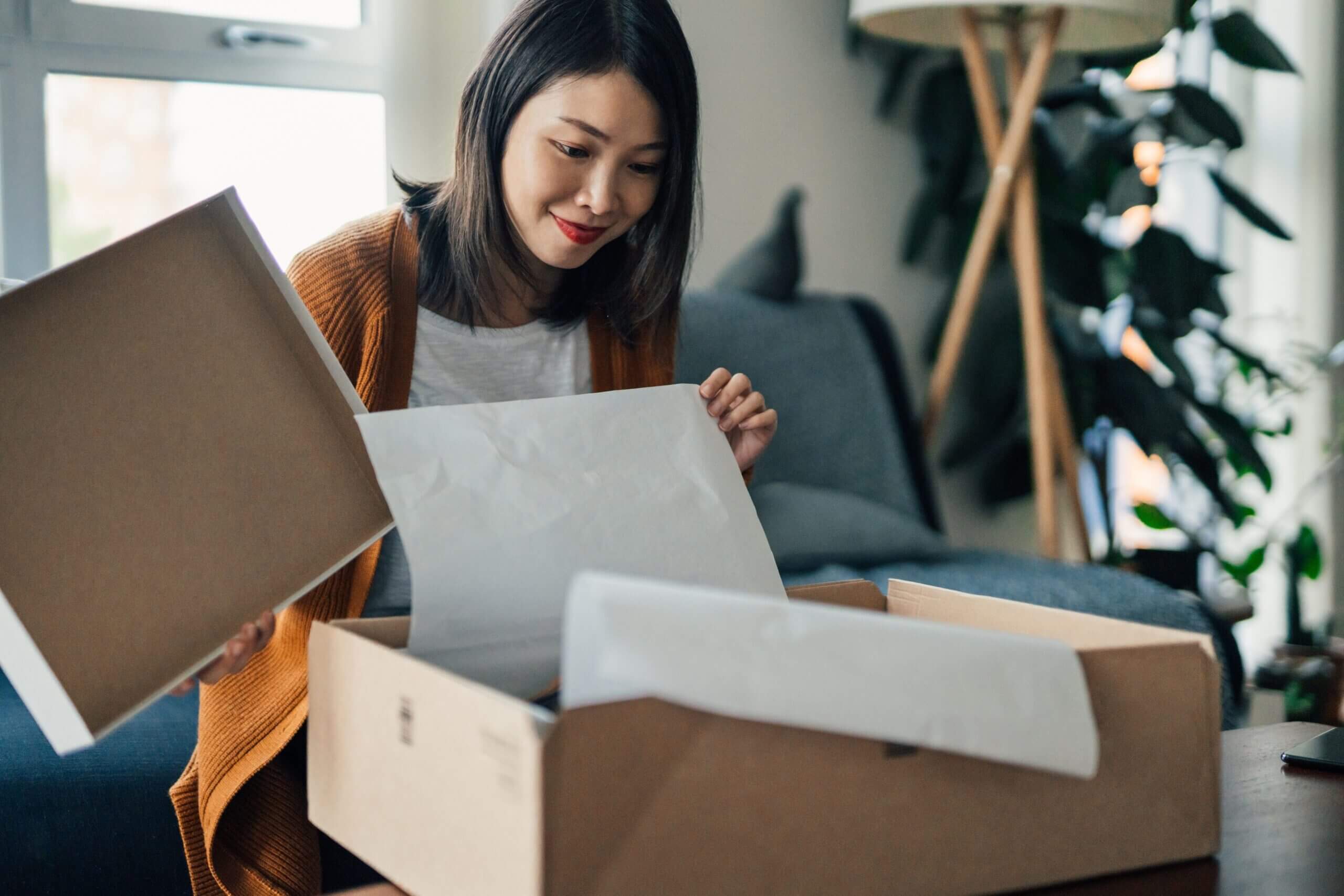 A woman opening a new product she has received as part of a new product launch campaign