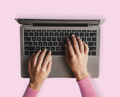 Hands typing on laptop